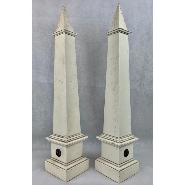 Pair of stunning tall faux ivory neo-classical obelisks. Edited design with each obelisk having only a single pair of gilt...