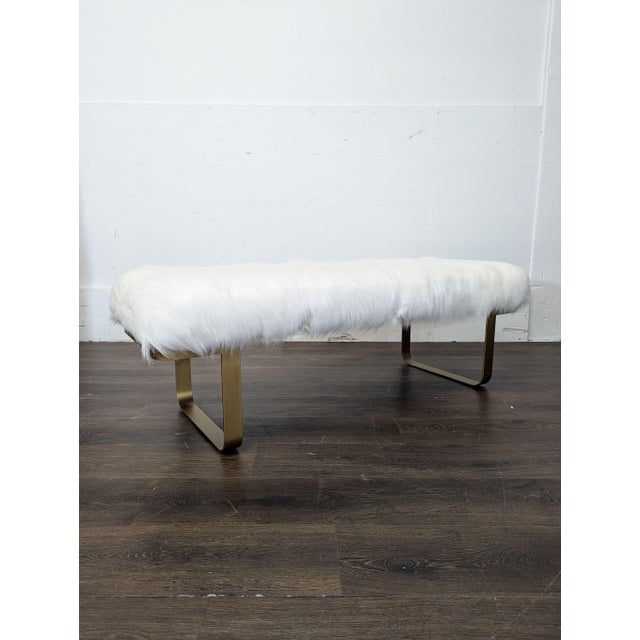 Faux fur bench on gilt metal sled legs. Brand: Restoration Hardware. Dimensions (in): 55W x 19D x 18H.
