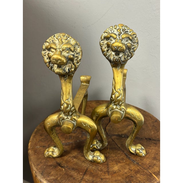 A striking pair of 19th century English brass lion andirons, full of presence and old-world character. Each features a...