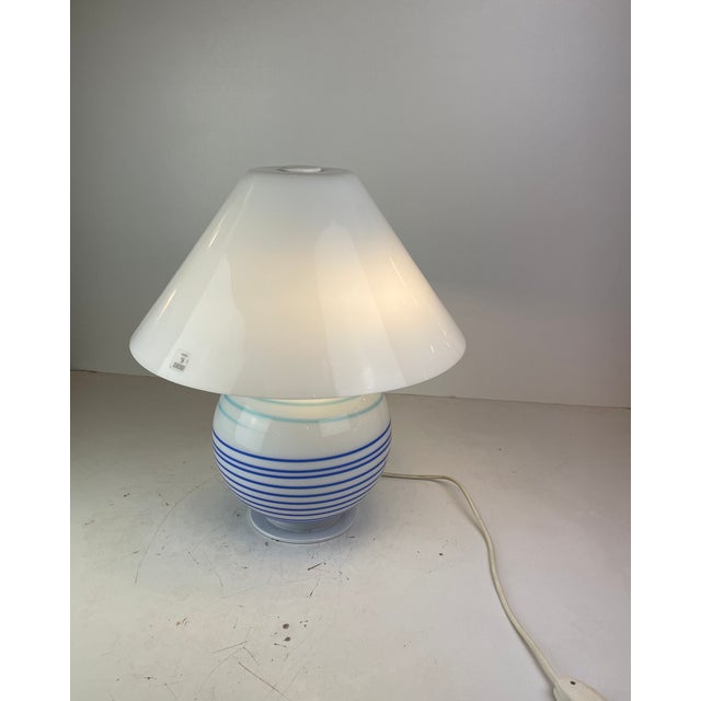 Large table lamp made of white satin Murano Glass with dark and baby blue lines and a white metal structure. Designed in a...