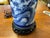 20th Century chinoserie table lamp. Porcelian and metal. Blue and white floral landscape scene.