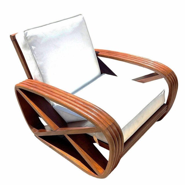 This beautifully restored pair of mid-century hand-carved four-strand faux rattan lounge chairs. Each features the square...