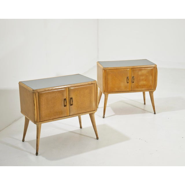 A stunning pair of vintage bedside tables, a classic example of Italian-made Midcentury Modern furniture dating back to...