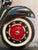 This oil on canvas artwork presents a close-up view of a Vespa Primavera 125, capturing the sleek lines and distinctive...