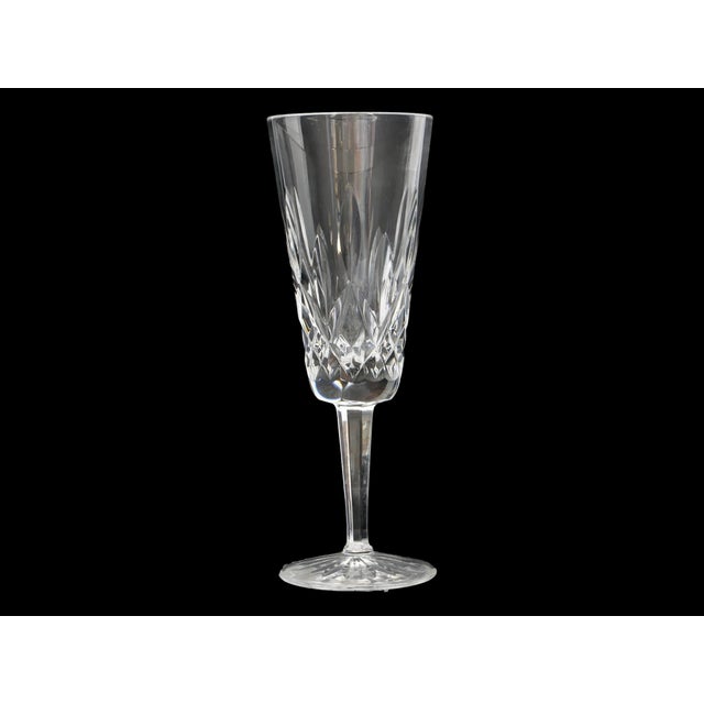 Pair of mid 20th century Waterford crystal champagne toasting flutes in the iconic Lismore pattern. The elegant tall forms...
