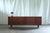 Vintage teak sideboard from 1960s Denmark with a clean mid-century modern design. The long, low structure features a...