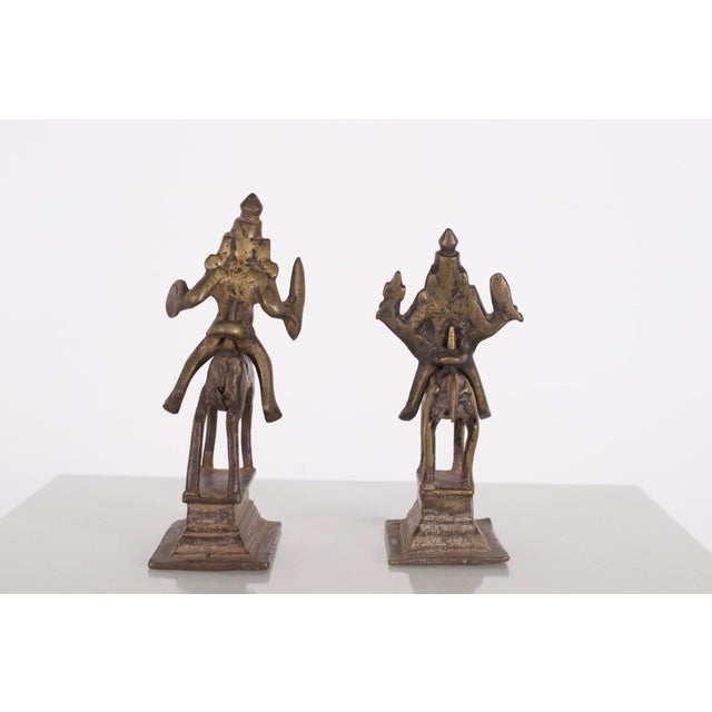 Pair of two brass statuettes depicting two horsemen, India, 19th century. The larger statuette measures 14 cm high x 6.5...