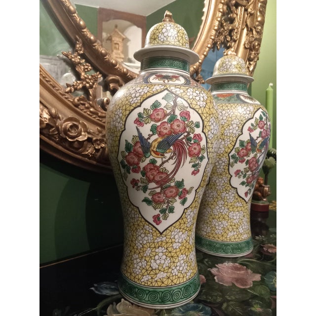 Gabriel FOURMAINTRAUX for DESVRES Pair of earthenware jars decorated with lotuses, birds and butterflies in cartridges on...
