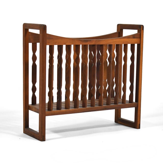 This lovely walnut magazine rack by Arthur Umanoff for Washington Woodcraft has sculptural spindles that create visual...