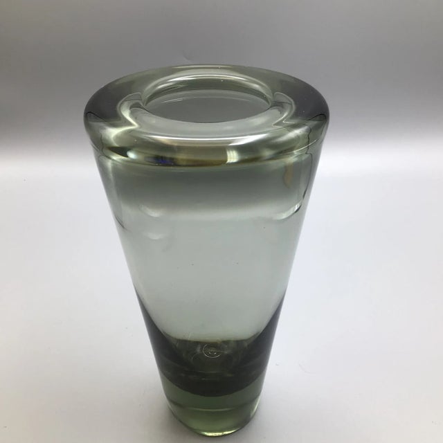 Here is a signed Holmegaard hand blown vase Measures 2.25 inches wide at the base. Signed on the bottom 1962.