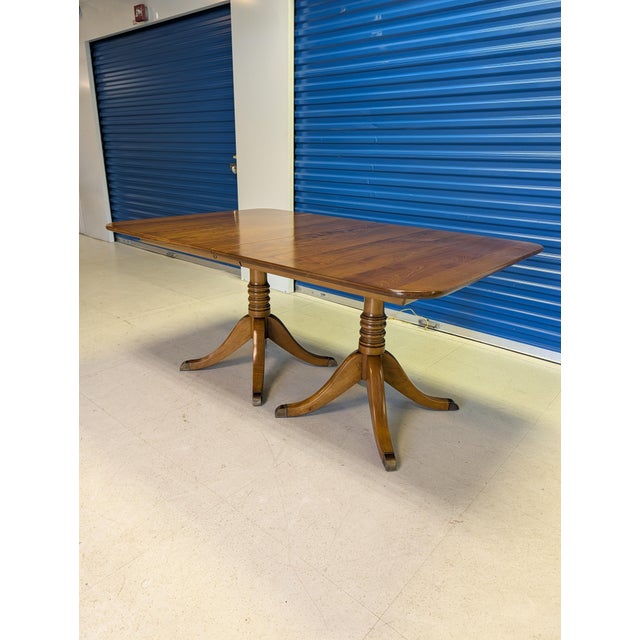 Elevate your dining space with this exceptional L. & J.G. Stickley double-pedestal extension dining table from the...