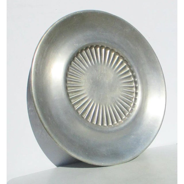Vintage Aluminum serving tray from the 50s. Hammered from solid sheet. Styled like a large hub cap. Smart 50s' take on the...
