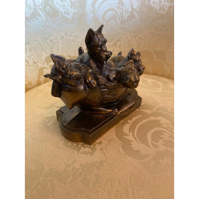 Metal Basket of Yorkie Pups in a Bronze Color and Pups are in a playful manner.