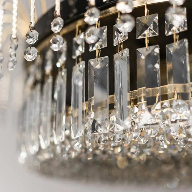 Chandelier from the 1970s. Chromed metal and brass structure. Glass pendants. Good condition, shows signs of time. 70s...