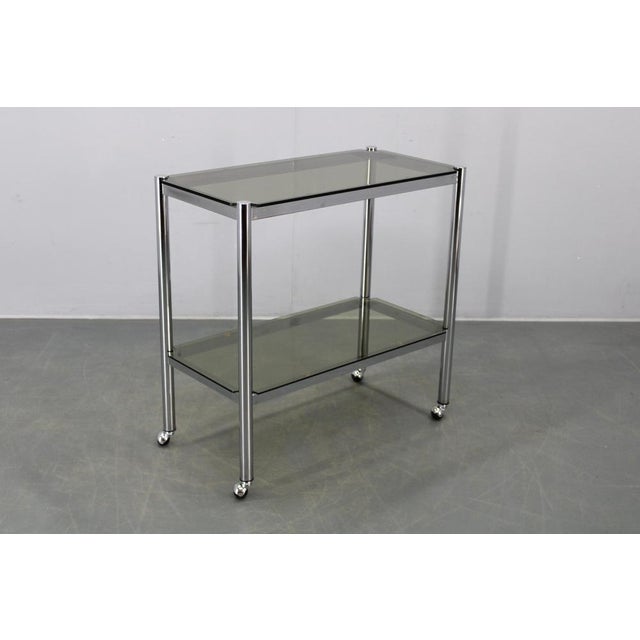 This elegant mid-century serving cart was produced in Italy during the 1970s and exemplifies the clean lines and refined...