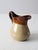 This is a vintage stoneware pitcher. Reminiscent of RRP, the farmhouse ewer features a two tone brown slip glaze.