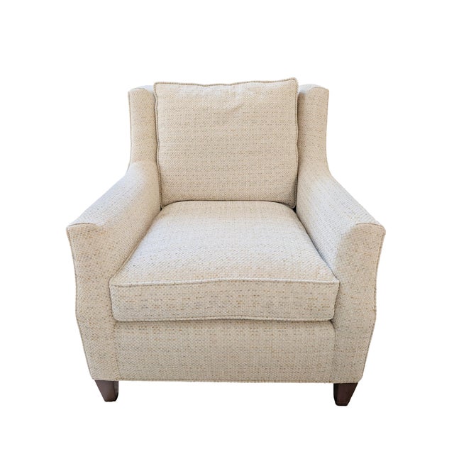 A striking pair of wingback club chairs upholstered in a nubby boucle fabric, with a sculptural swooping arm profile that...
