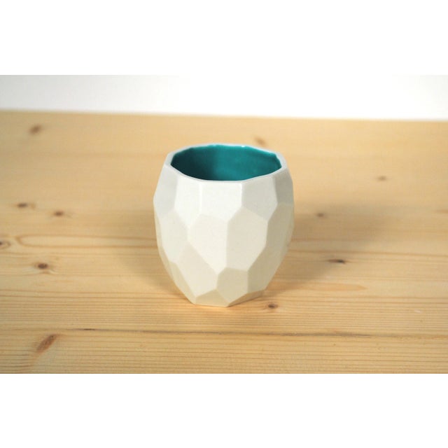 Porcelain tableware at a low resolution. Instead of smooth shapes, this pottery made piece is built up out of polygons. It...