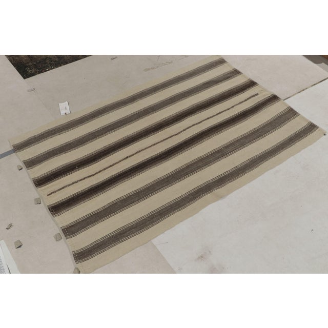 A 5x7 vintage kilim rug from our flatweave selections, originating from Turkey circa 1960-1970. Handwoven in all wool, the...