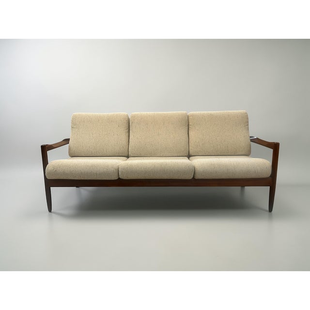 An exceptional Scandinavian Modern three-seat sofa from the 1960s, featuring a sculptural design language strongly...