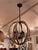 Design Plus Gallery presents a Wooden Block Orb Chandelier with a Black Metal Frame from Anthem. Intersecting wood block...