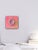 This mixed media piece features a vibrantly colored donut, adorned with a playful array of multicolored sprinkles, set...