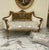 Elegant French Rococo sofa upholstered in luxurious white and beige damask, featuring exquisite hand-carved details and a...