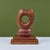 Hand-carved wooden abstract cat head. The piece showcases two pointed ears and whiskers on each side of the face. The...