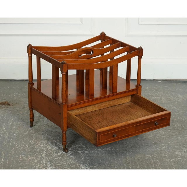 Vintage Walnut Wood Magazine Rack. A vintage walnut Canterbury newspaper rack with brass handles is a charming and elegant...