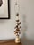 This vintage table Italian Regency table lamp features a delicate, hand-painted, tiered, ivory base with gold floral and...
