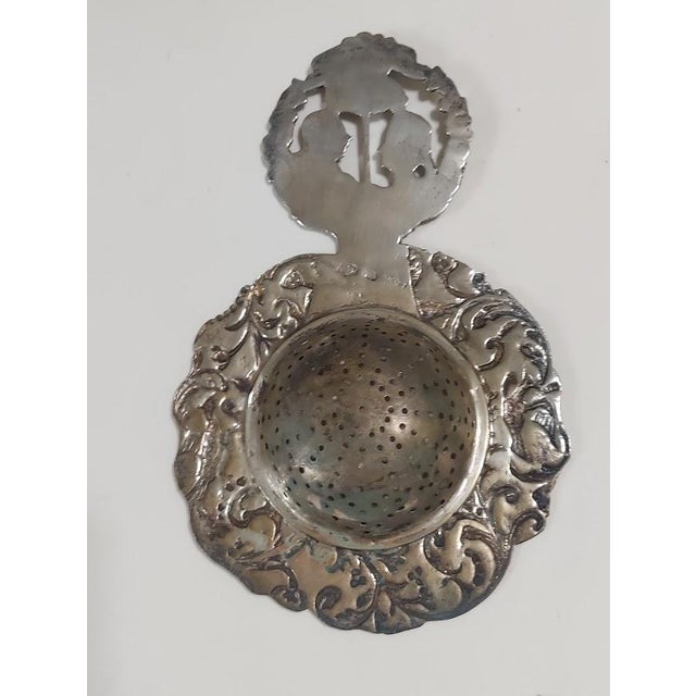 Exceptionally ornate antique German Hanau 800 silver tea stainer, dating back approximately to 1890-1910. Features...