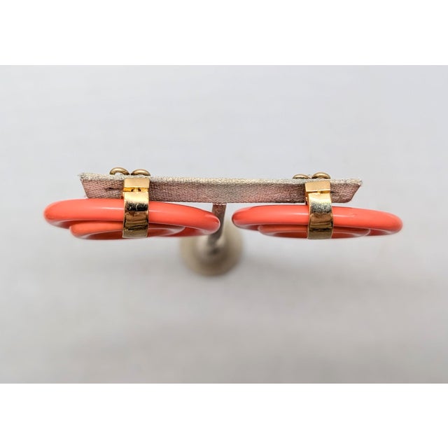 1950s goldtone two coral pink resin hoops one inside the other with smooth goldtone top butterfly clip back earrings....