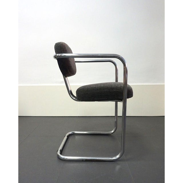 Chair with a suspended seat, a very characteristic design from the 1970s. Minor signs of wear on the chrome. Reupholstered...