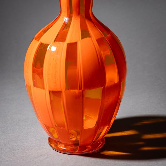 Large glass vase with a long neck, bulbous body, and low circular foot. Executed in a combination of transparent and...