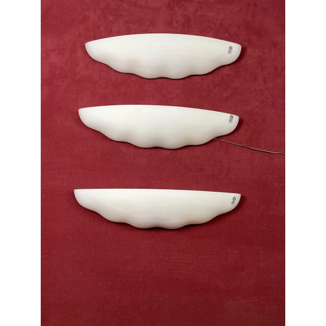 Set of 3 large Leucos wall lamps in opaline blown Murano glass, 1980s Intact and in good condition. Metal structures. Two-...