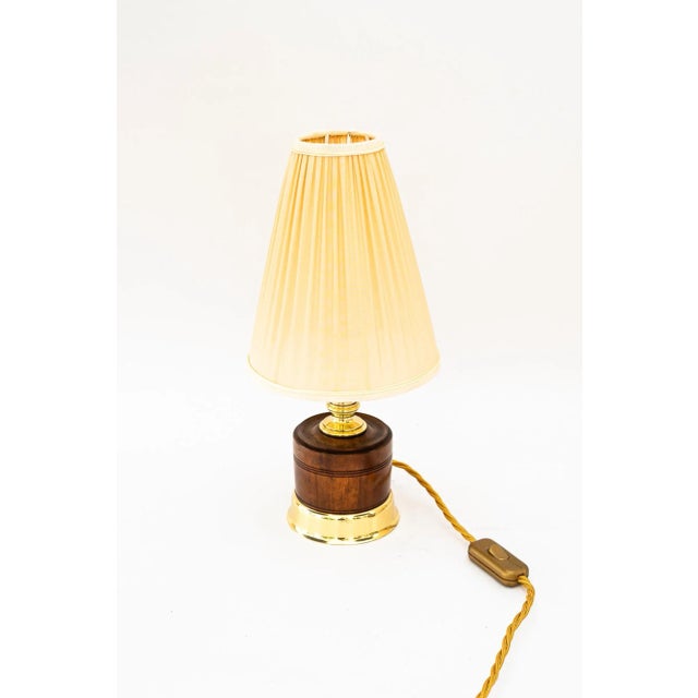 Table lamp with original nut wood brass and fabric shade vienna around 1920s European Plug (up to 250V).The wiring of this...