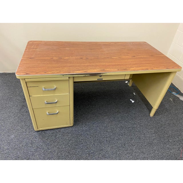 McDowell and Craig vintage mid century modern single pedestal tanker desk with a filling drawer in light mustard yellow...