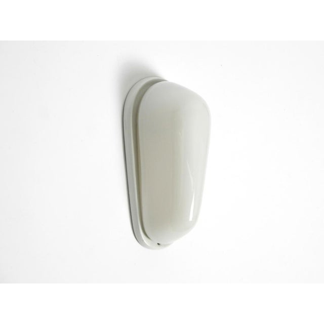 One rare mid-century modern glass and ceramic wall lamp. design by wilhelm wagenfeld. minimalist design in glass. Ceramic...