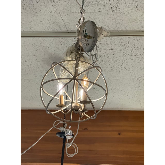 Design Plus Gallery presents the Solaris Mini Chandelier by Crystorama. The light fixture has intersecting metal rings...