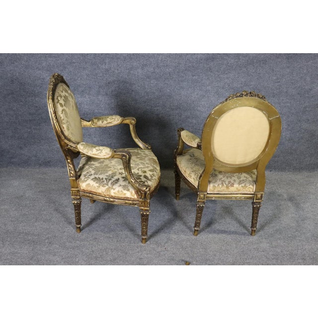 This elegant pair of French Louis XVI style armchairs embodies the timeless refinement and restrained luxury that have...