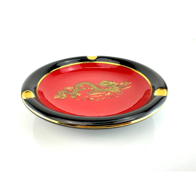 Handmade in Italy for Hoygill Imports, this ceramic ashtray makes a bold statement with its glossy black rim, vivid red...