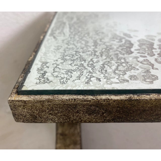 This is a vintage French country style distressed wrought iron cocktail table. This cocktail table has a antique mirrored...