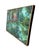 A loosely brushed impressionist acrylic painting of a garden pond, set in a simple oak-toned frame. The reflective water...