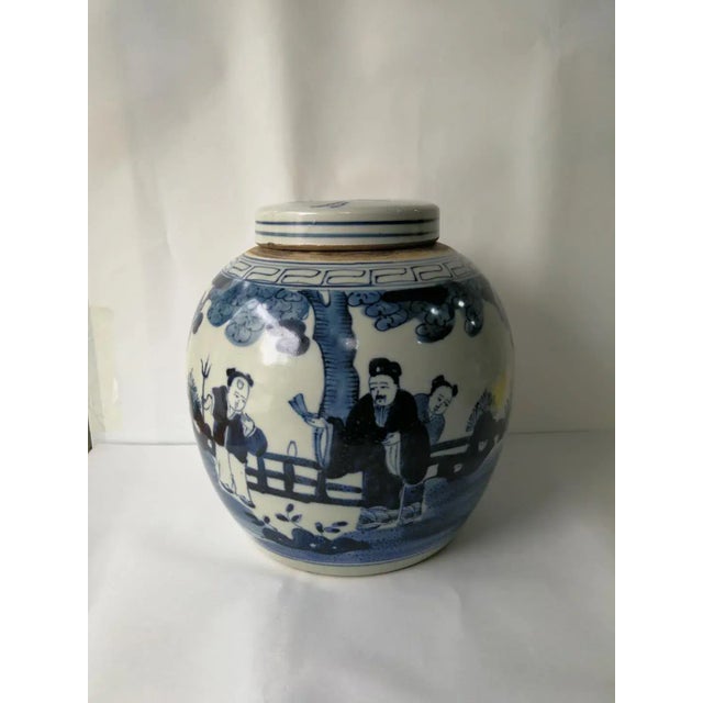 A beautiful blue and white finished porcelain ginger jar with the hand painted human figures. This lidded jar is not just...