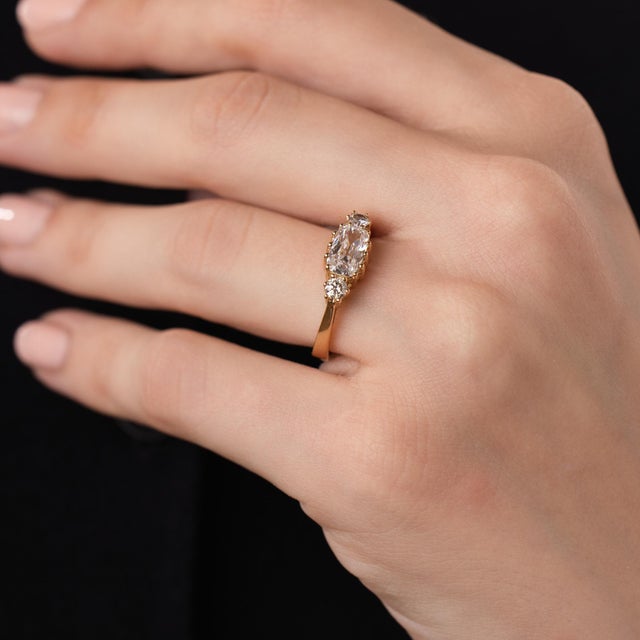 This elegant vintage diamond east west ring is a distinctive 1970’s design, centered by a GIA-certified cushion brilliant...