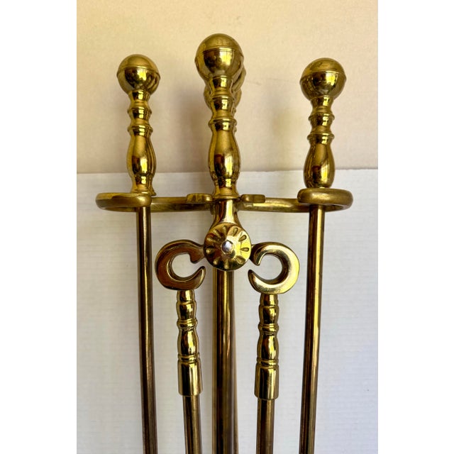 Here is a vintage five-piece brass fireplace tool set with substantial construction and wonderful decorative detailing....