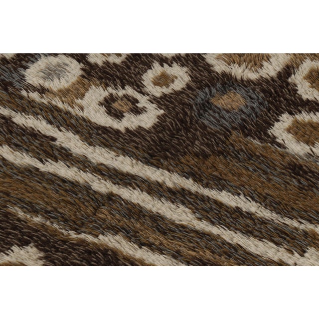 Hand-knotted in lush, high-pile wool in Sweden circa 1960-1970, this 5x7 vintage Swedish Rya rug is a bold new addition to...