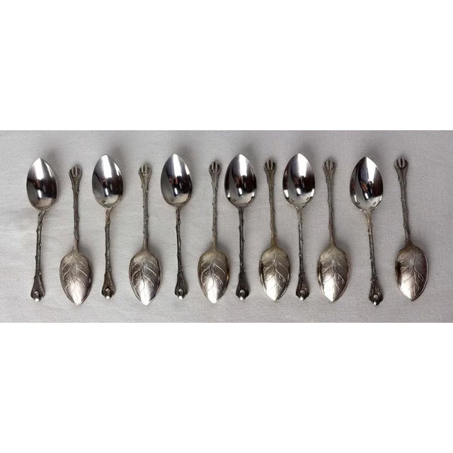 French silver metal set of twelve spoons. The back of each spoon represents a very well executed leaf whose details are...