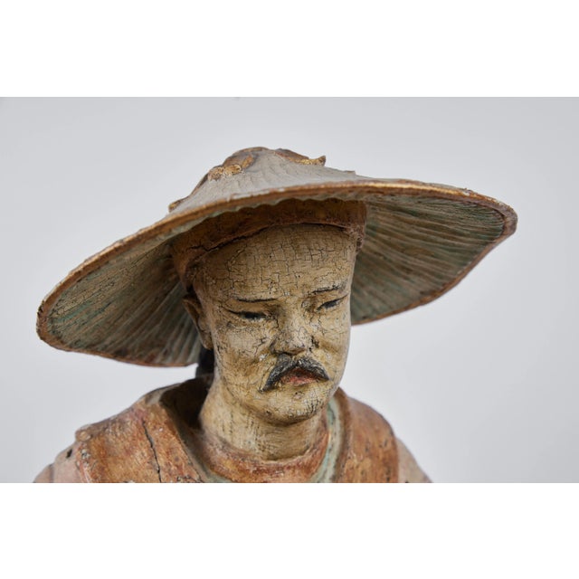 An elegant, turn-of-the-19th century, hand-carved, fully finished polychrome and parcel gilt statue of a Chinese wise man...