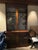 Elegant antique mahogany two-piece display cabinet with handsome architectural detailing and beautifully patterned...
